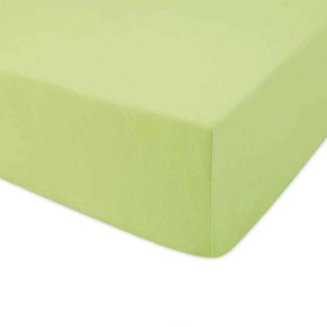 Prześcieradło jersey z gumką w kolorze limonkowym, o wymiarach 90x200 cm, leżące na płaskiej powierzchni. Materiał gładki i elastyczny, dobrze dopasowujące się do materaca.