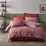 Pościel bawełniana 220x200 Cottonlove Jacquard Marble Terra w kolorze terakoty z wzorem marbled. Złożona na łóżku, z poduszkami w tym samym stylu. Tło w stonowanych odcieniach, nawiązujące do naturalnych barw. Widoczne detale tekstury materiału.