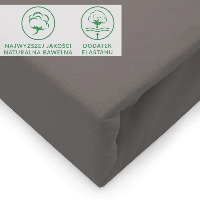 Prześcieradło jersey z elastanem w kolorze antracytowym, o wymiarach 180x200 cm, z gumką. Materiał jest gładki, elastyczny, dobrze przylegający do materaca, co zapewnia komfort użytkowania. Widoczne ikony informujące o jakości bawełny i dodatku elastanu.