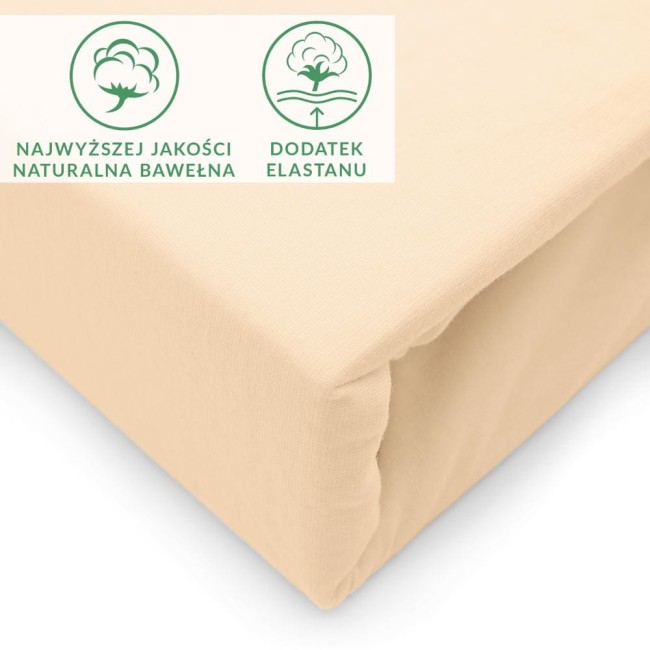 Prześcieradło jersey z elastanem w kolorze beżowym, rozmiar 90x200, leżące na płaskiej powierzchni. Widoczna gładka struktura materiału oraz elastyczny brzeg zapewniający dopasowanie.