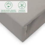 Prześcieradło jersey z elastanem w kolorze popielatym, rozmiar 140x200 cm, z gumką. Widok z boku pokazujący rozłożony produkt z wyraźną fakturą materiału. Na tkaninie znajdują się logo i oznaczenia dotyczące jakości materiału.