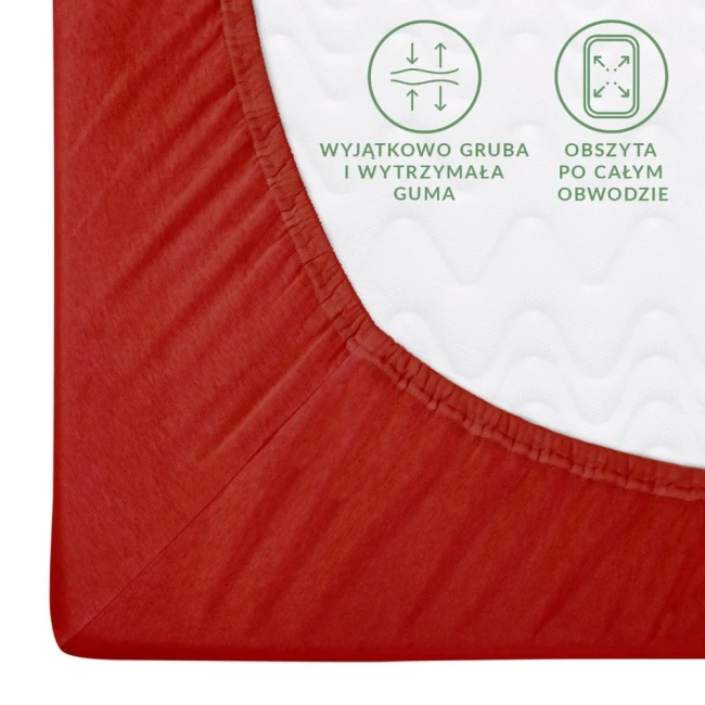 Czerwone prześcieradło jersey z gumką w rozmiarze 120x200, widok z boku. Materiał elastyczny, obszycie gumką widoczne. Na białym tle pojawiają się napisy o grubości i wytrzymałości gumy. Tekstura dzianiny gładka.