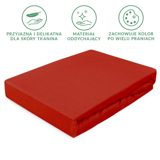Prześcieradło jersey z gumką 90x200 w kolorze intensywnej czerwieni, leżące na boku. Materiał oddychający, podatny na rozciąganie. Widoczne właściwości: przyjazna dla skóry tkanina, zachowująca kolor po wielu praniach.