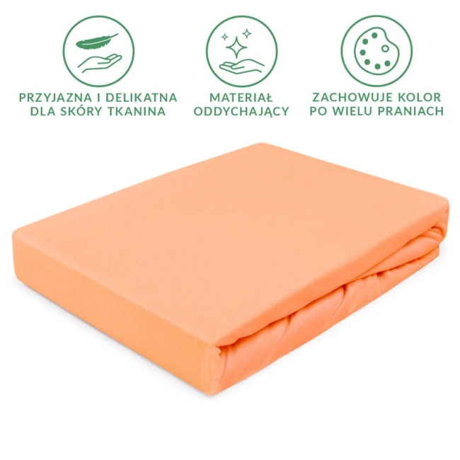 Prześcieradło jersey z gumką 140x200 w kolorze łosoś, leżące na białym tle. Wykonane z oddychającego materiału, zapewniającego wygodę. Z delikatną teksturą i elastyczną gumką. Widoczne informacje o trwałości koloru po wielu praniach.