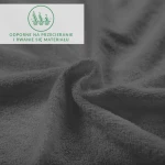 Prześcieradło frotte z gumką 140x200 w kolorze antracytowym, o teksturowanej powierzchni, leżące na gładkiej nawierzchni. Widać detale materiału, podkreślające jego miękkość. Na górze umieszczona informacja o odporności na przetarcia.