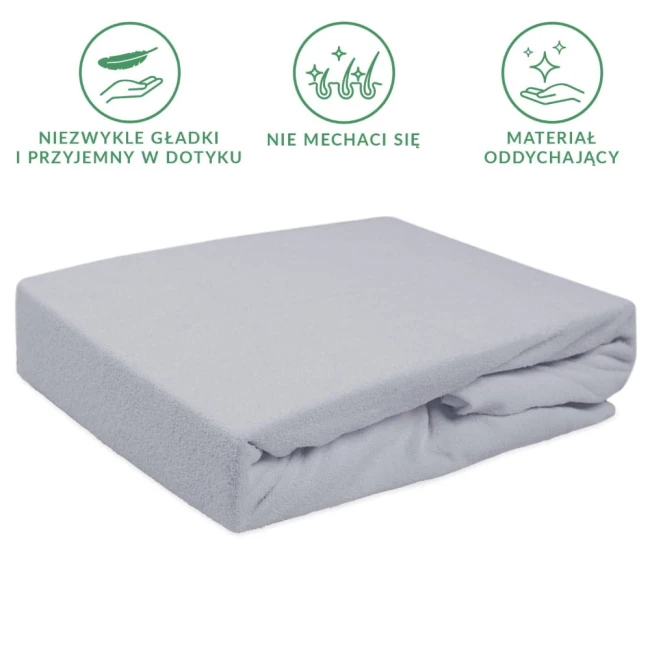 Prześcieradło frotte z gumką w kolorze popielatym, o wymiarach 140x200 cm, leży w złożonej formie na jednolitym tle. Materiał jest teksturowany, miękki i przyjemny w dotyku, bez widocznych napisów oraz logo.