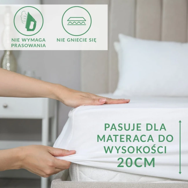 Prześcieradło frotte z gumką w kolorze popiel, o wymiarach 160x200 cm, rozłożone na materacu. Ujęcie z boku, pokazujące elastyczną gumkę ułatwiającą dopasowanie.