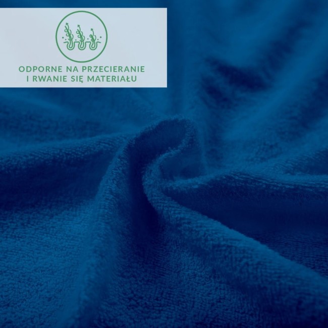 Prześcieradło frotte z gumką w kolorze chabrowym, pokazane w zbliżeniu, na niejednolitym tle. Widoczna tekstura materiału, który jest miękki i gładki. Prześcieradło ma elastyczną gumkę, zapewniającą dobre dopasowanie.