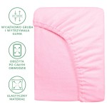 Prześcieradło frotte 180x200 w jasnym różu, z gumką umieszczoną na całym obwodzie. Materiał elastyczny, gładki w dotyku. Ułożone leżąco, pokazujące kształt i fakturę. Fotel to proste tło, co podkreśla kolor i detale produktu.