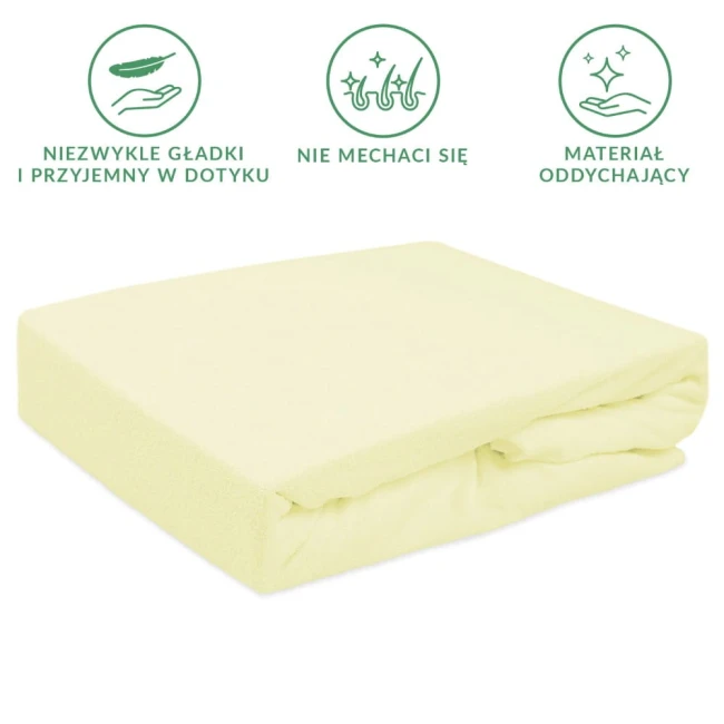 Prześcieradło frotte z gumką 200x220 w kolorze kremowym, leżące na boku. Wykonane z materiału oddychającego, gładkiego i przyjemnego w dotyku, nie mechaci się. Idealne do komfortowego użytku.