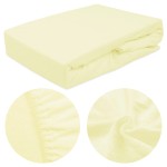 Prześcieradło frotte z gumką 70x140 w kolorze kremowym, leżące na płasko. Wyraźne detale gumki na brzegach oraz tekstura materiału ukazana w zbliżeniu. Gładka powierzchnia i elastyczne wykończenie. Idealne do łóżeczek dziecięcych.