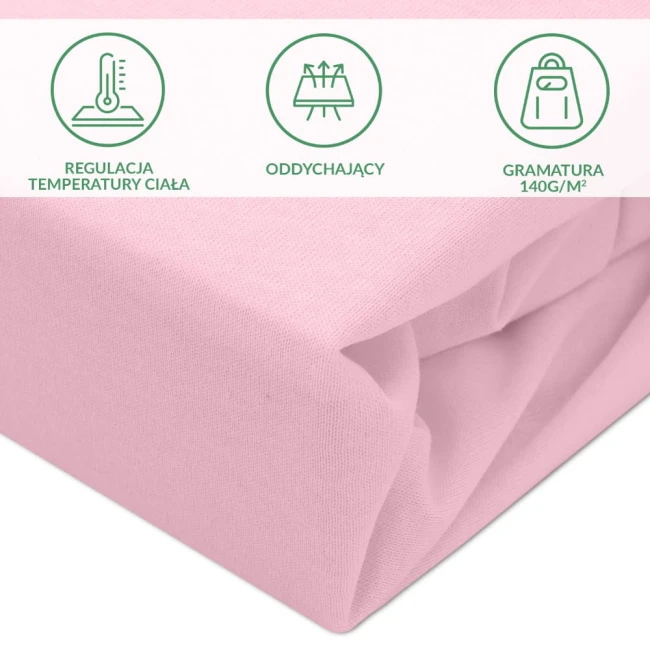 Ochronne prześcieradło z gumką w rozmiarze 80x200 cm, w kolorze różowym, wykonane z materiału o gramaturze 140 g/m². Zbliżenie na fakturę dzianiny, z widocznymi symbolami: regulacja temperatury ciała, oddychający, gramatura.
