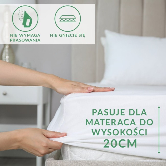 Prześcieradło frotte w kolorze różowym perłowym, leżące na materacu, z widoczną gumką i napisem PASUJE DLA MATERACA DO WYSOKOŚCI 20CM. Na zdjęciu pokazano, jak łatwo można je założyć. Tło jasne, minimalistyczne.
