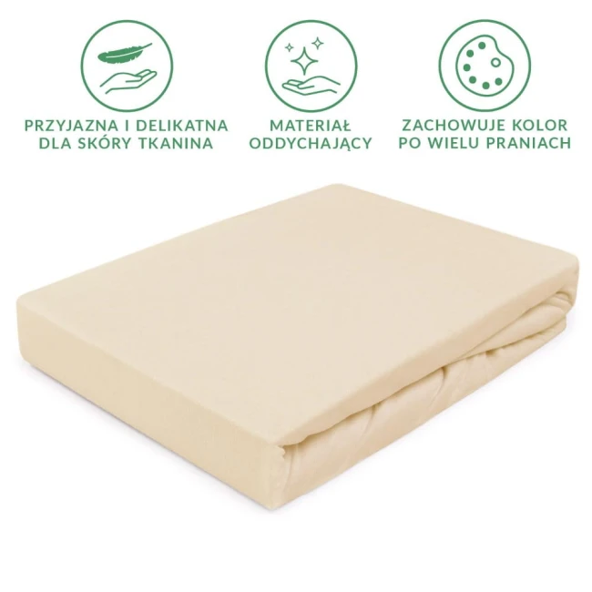 Prześcieradło jersey z gumką 140x200 w kolorze jasnego beżu leży płasko na białym tle. Wykonane z tkaniny przyjaznej dla skóry, ma delikatną, teksturowaną powierzchnię. Widoczne są podwinięcia, a gumka zapewnia dobrze dopasowane ułożenie na materacu.