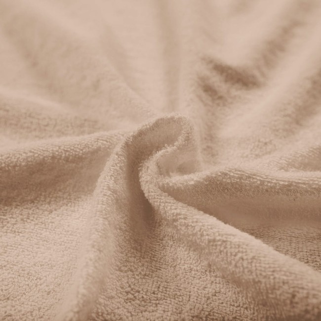 Pościel frotte w kolorze beżowym, rozłożona w delikatny sposób, ukazująca miękką, teksturowaną powierzchnię. Zdjęcie zbliżeniowe, skupiające się na fakturze materiału, bez widocznych napisów lub logo.