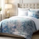 Pościel satyna bawełniana 160x200 Luxury Premium Belize w niebiesko-białym kolorze, ukłożona na łóżku. Dekomponuje się z białymi poduszkami oraz narzutą. Widoczne drobne wzory w odcieniach niebieskiego na tle białym, z miękką, teksturowaną powierzchnią.