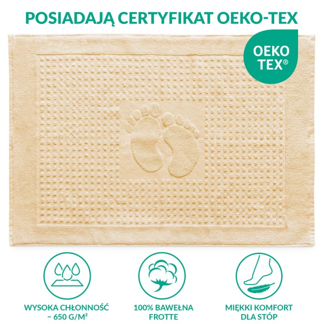 Dywanik łazienkowy 50x70 cm w kolorze kremowym, z wypukłym wzorem stóp na środku. Materiał tekstylny, z delikatną fakturą, leżący na białym tle. Zdobienia w postaci małych, regularnych kropek na całej powierzchni, rogami lekko zaokrąglony.