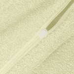 Pościel frotte 135x200 w kolorze kremowym, z widocznym zamkiem błyskawicznym. Materiał o teksturowanej, miękkiej powierzchni, idealny do użytku w sypialni. Ujęcie zbliżeniowe na detal zamka.